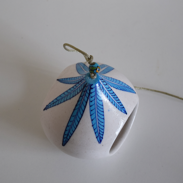 white tea light with blue leaf pattern