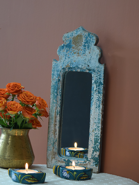 distressed blue dome mirror against terracotta background
