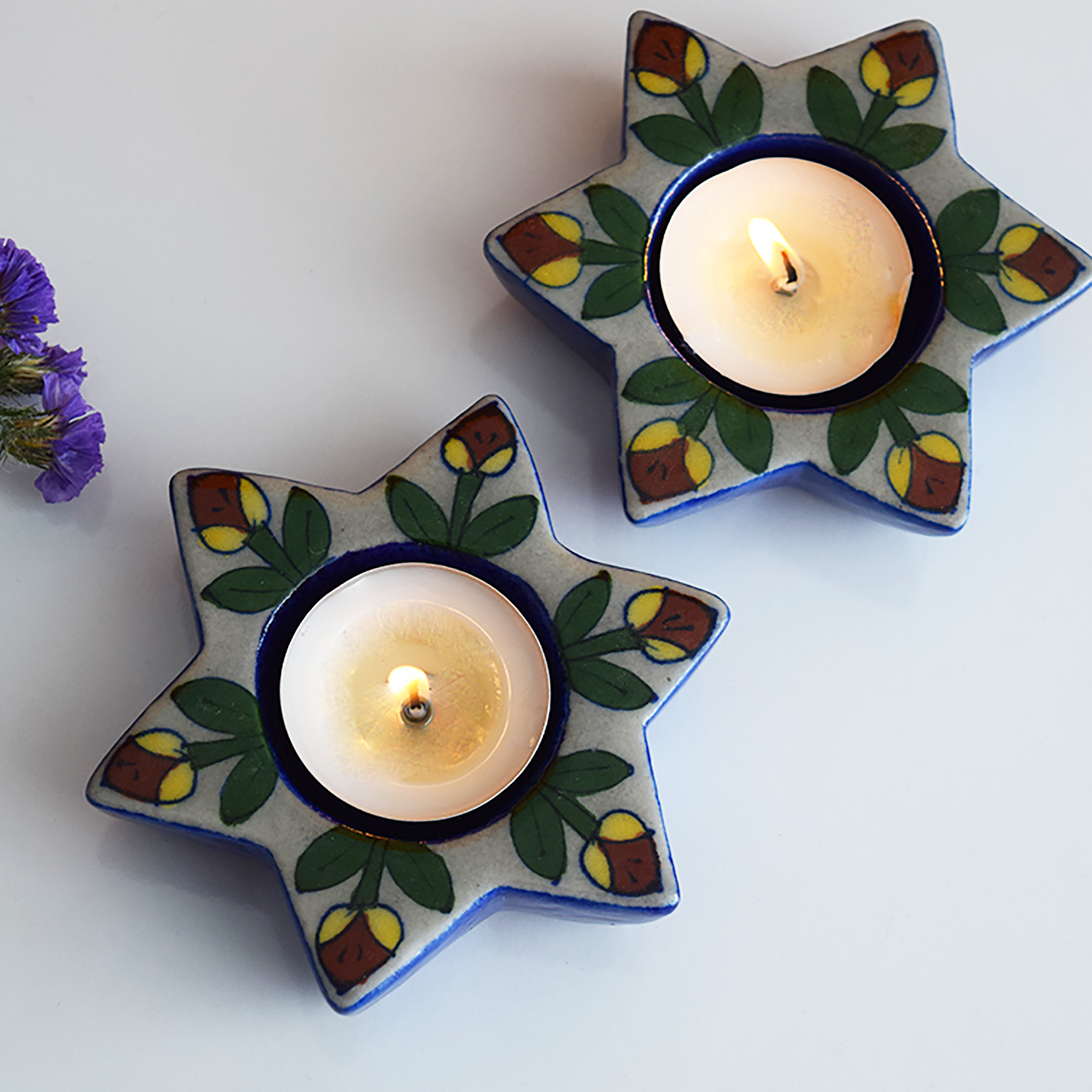 Blue star shaped diya with yellow and red hand painted flowers