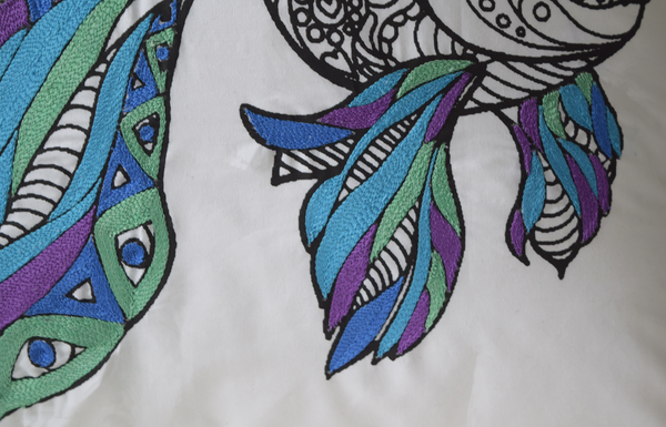 Fish cushion cover in mandala pattern with blue, purple and green embroidery