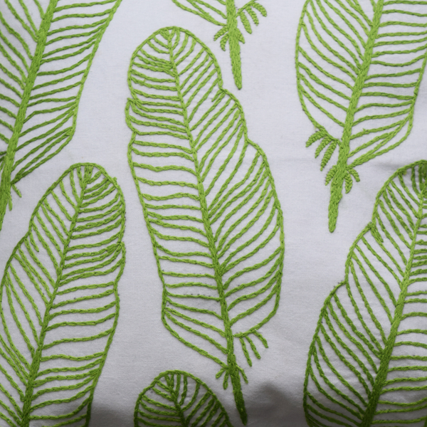 Green feathers embroidery details on cushion cover