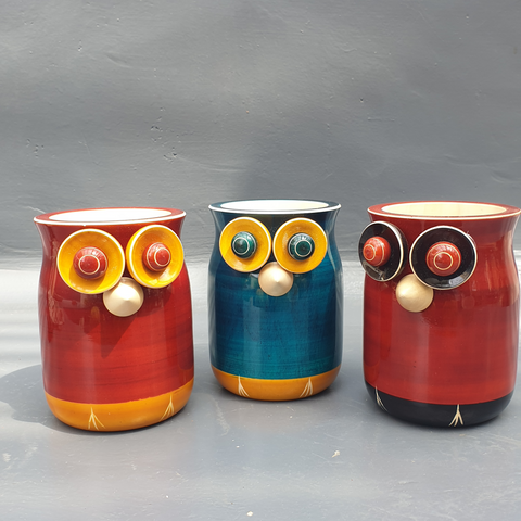 red-yellow, blue-yellow and red-black wooden owl pen stands