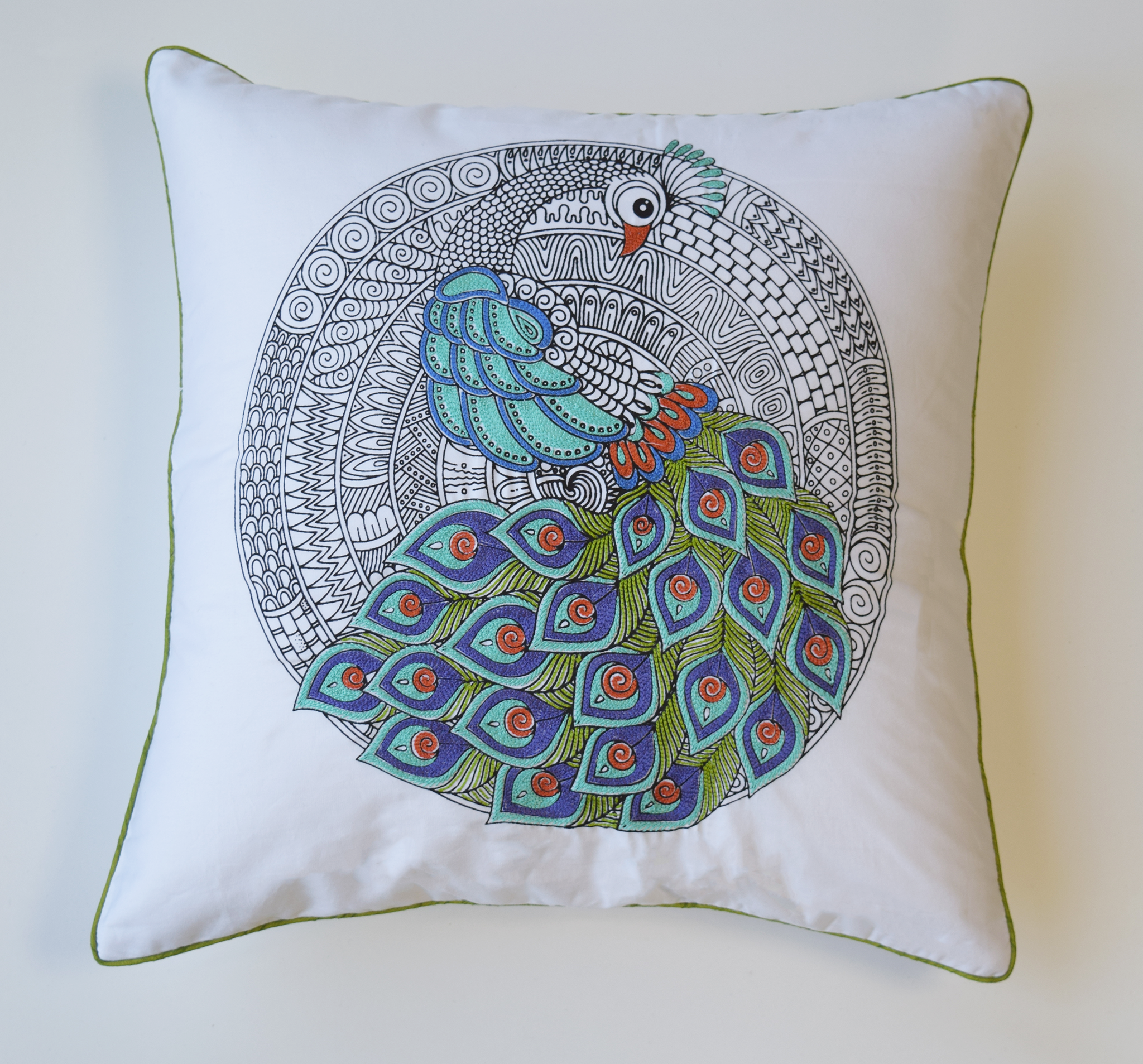 Emboidered peacock cushion cover in blue, green and rust embroidery