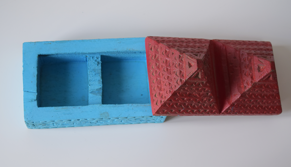 top view of a pyramid box- turquoise base and red pyramid top