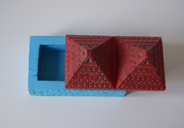 top view of a pyramid box- turquoise base and red pyramid top