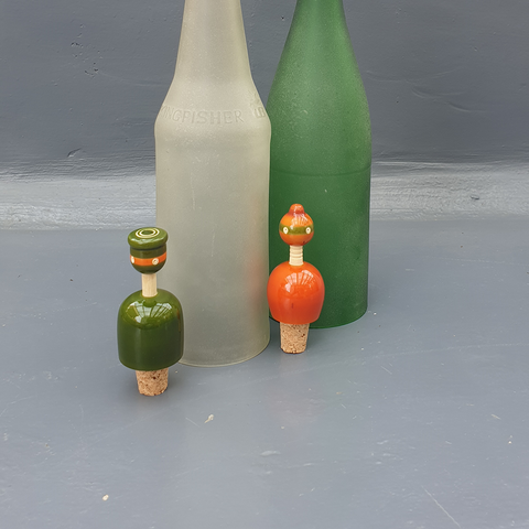green and orange wooden bottle stoppers