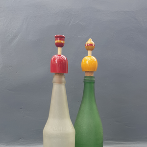 red and yellow wooden bottle stoppers