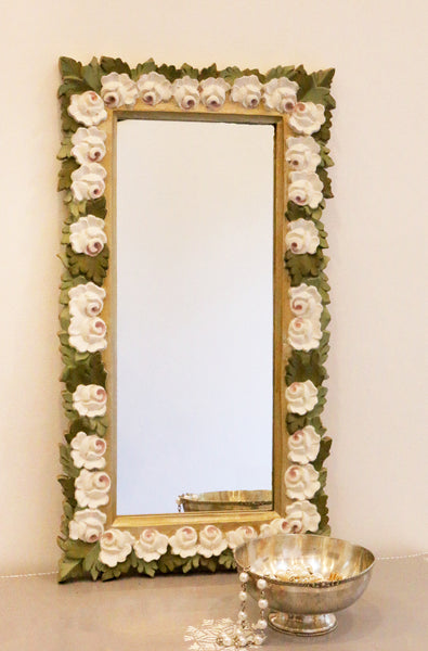 front image of gold frame with all around white roses and green leaves