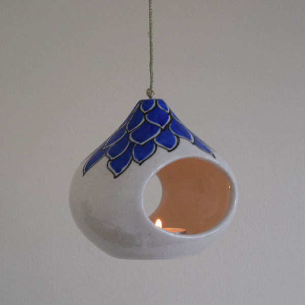 white tea light with blue flower pattern