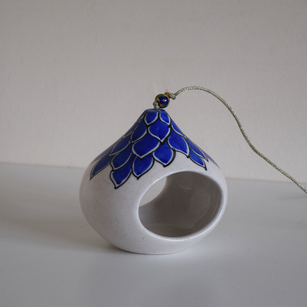 white tea light with blue flower pattern