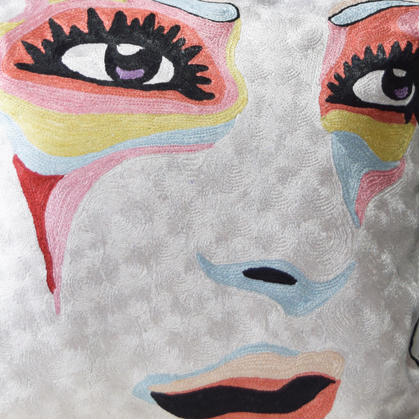 details of abstract face on white cushion