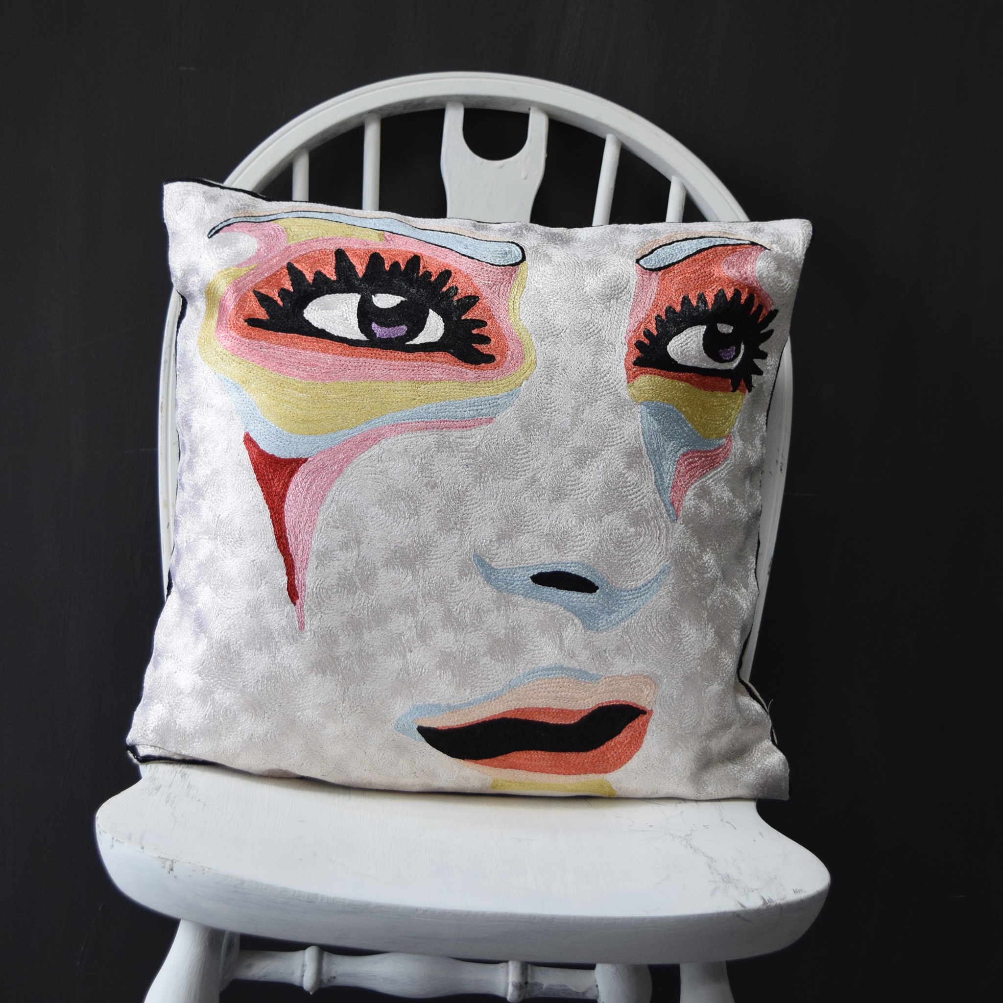 abstract face on white cushion