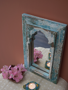 distressed blue minaret mirror against terracotta background