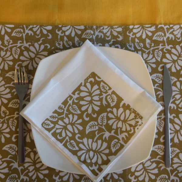 Mustard table runner with brown and white table mat and napkin