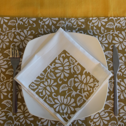 Mustard table runner with brown and white table mat and napkin